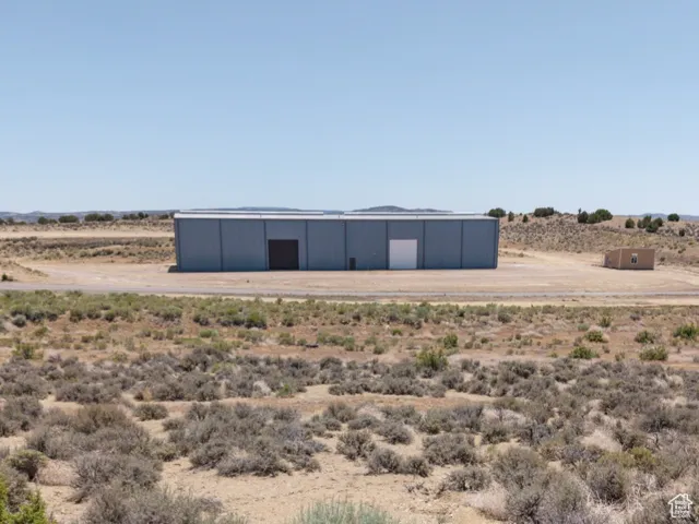 Exterior space with a pole building, a view of countryside, and an outdoor structure