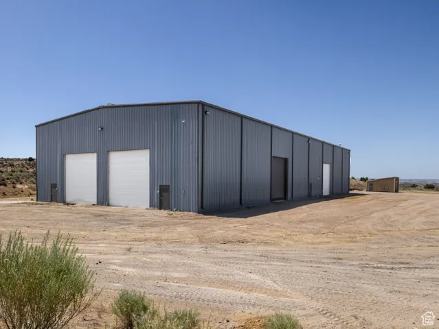 View of outbuilding featuring driveway