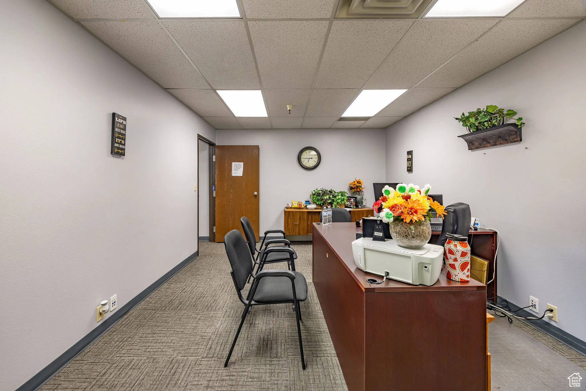 Home office featuring a paneled ceiling and carpet