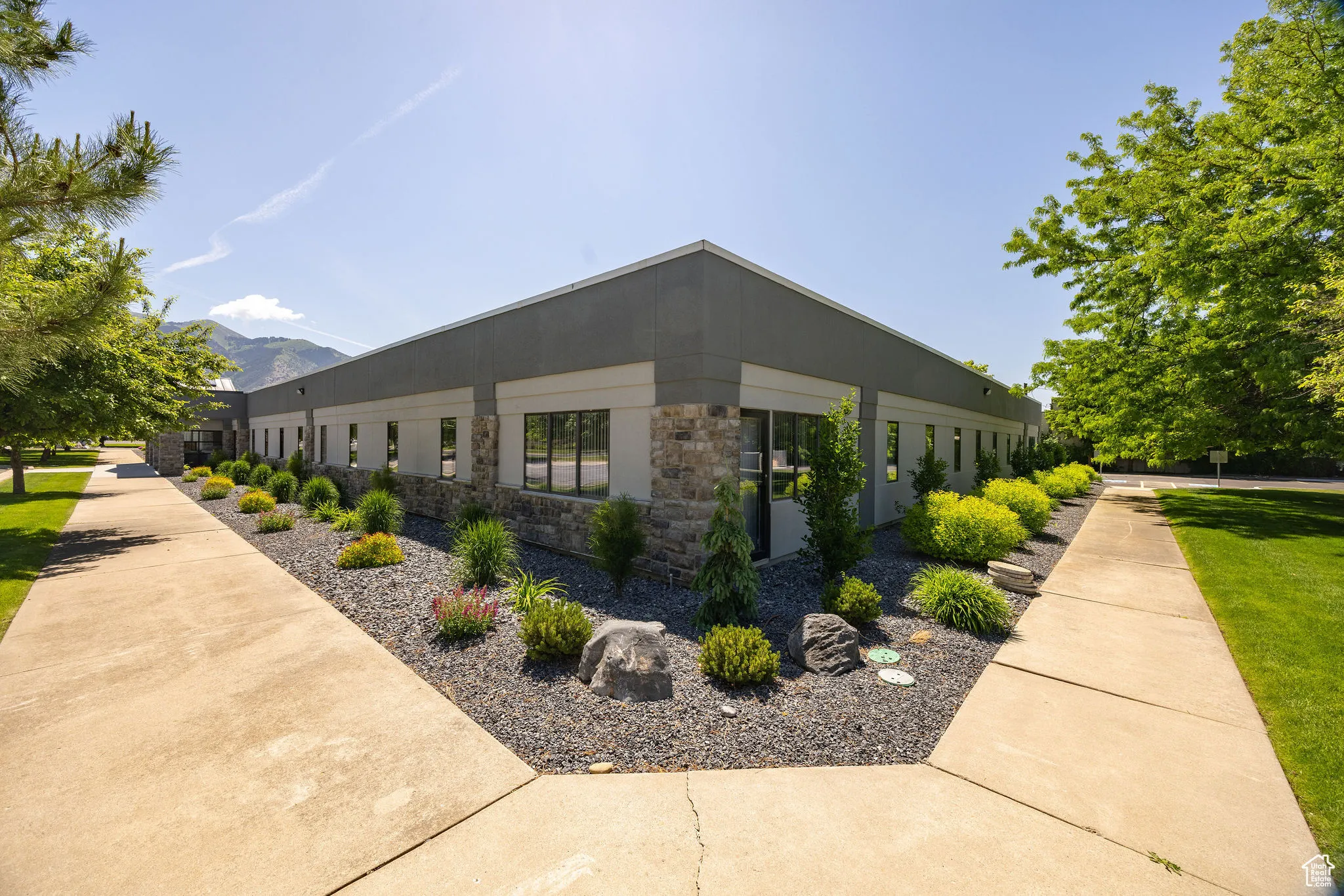 View of property exterior featuring stone siding and a mountain view