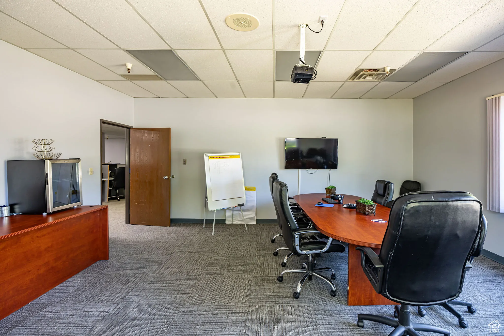 Office space featuring a paneled ceiling and carpet floors