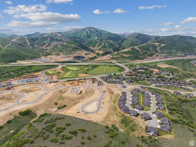 Aerial view of property's location with a mountainous background
