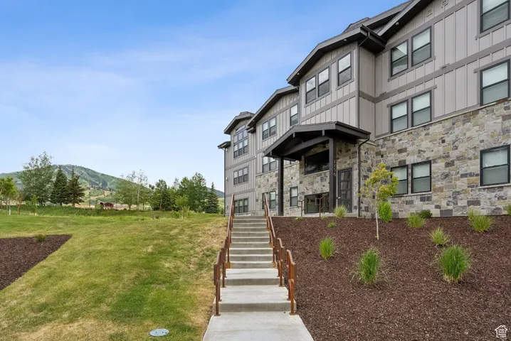 View of building exterior featuring stairs and a mountain view