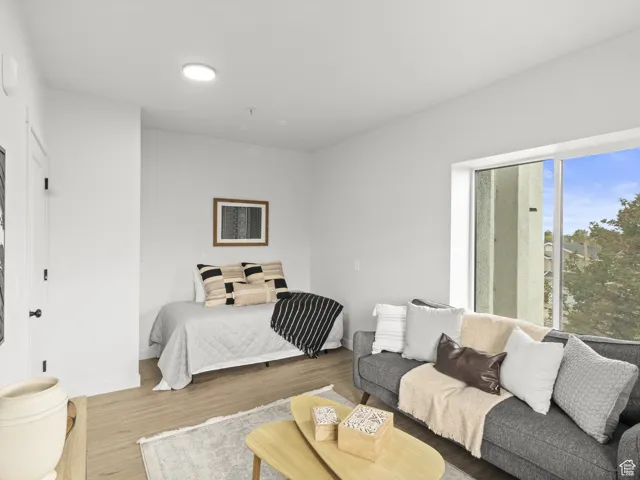 Bedroom featuring wood finished floors and baseboards