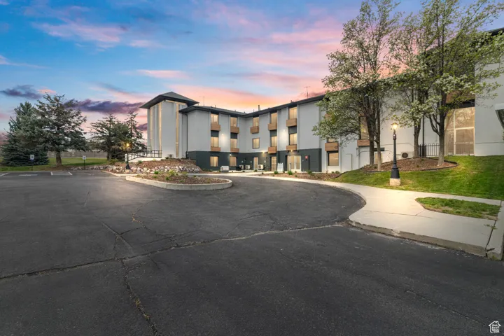 View of property at dusk