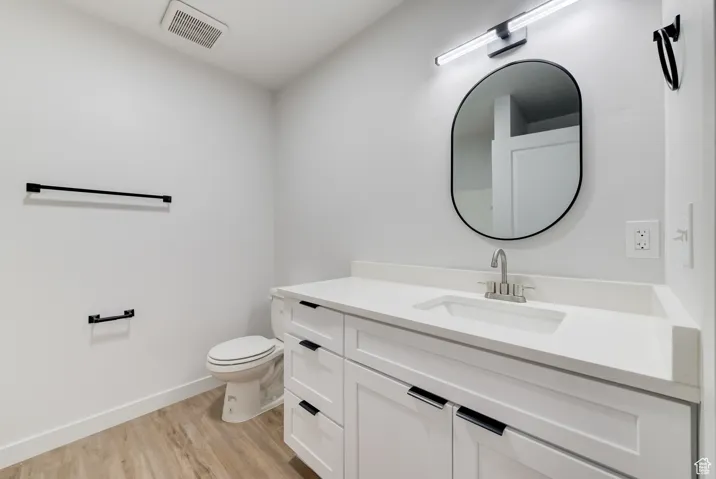 Bathroom featuring vanity and wood finished floors