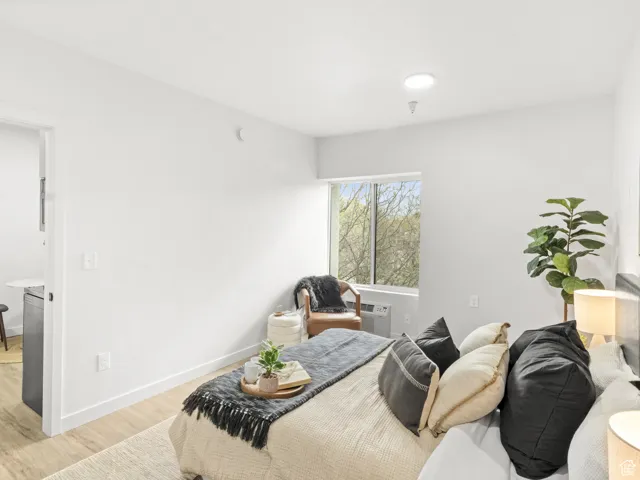 Bedroom with light wood-type flooring and baseboards