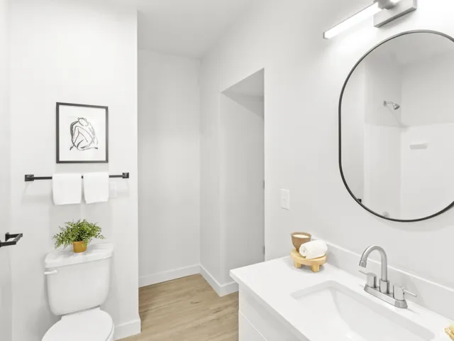 Full bathroom with vanity and wood finished floors