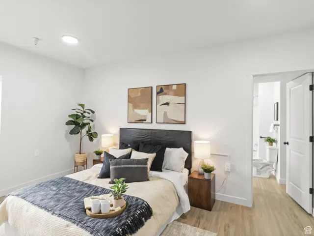 Bedroom featuring baseboards and wood finished floors