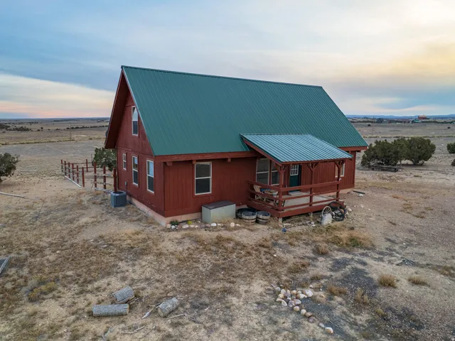 View of front of home with a metal roof and a rural view