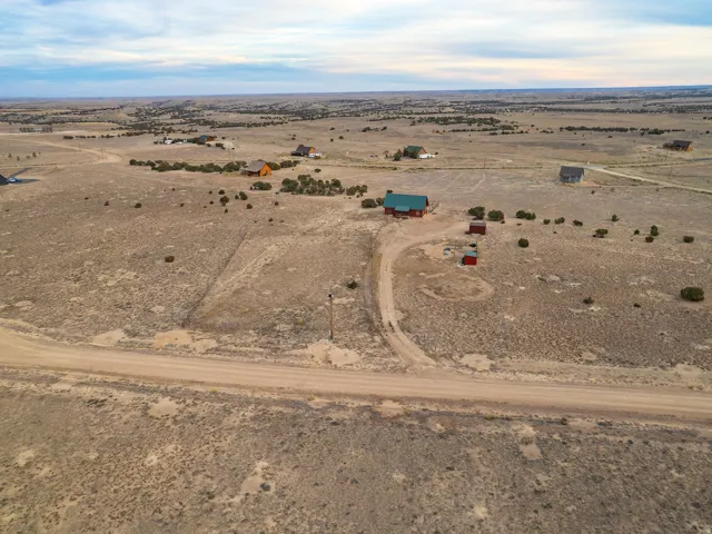 Aerial view of property and surrounding area featuring rural landscape and a desert landscape