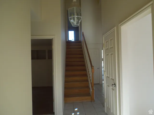 Staircase featuring tile patterned floors