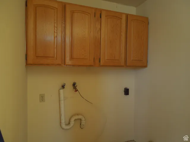 Washroom featuring cabinet space, hookup for an electric dryer, and washer hookup