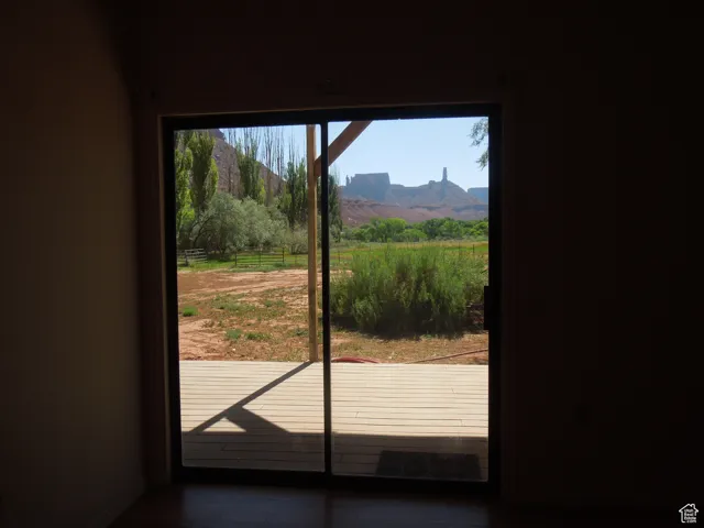 Doorway to outside featuring a mountain view and baseboards