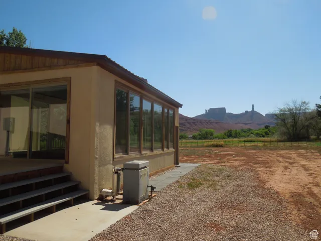 View of yard with a mountain view and a sunroom