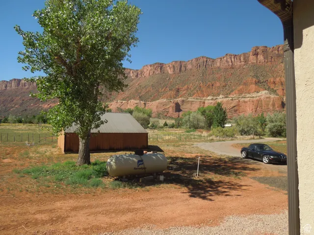 View of yard featuring a mountain view, an outbuilding, and an outdoor structure