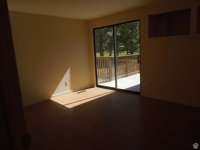 Empty room featuring wood finished floors