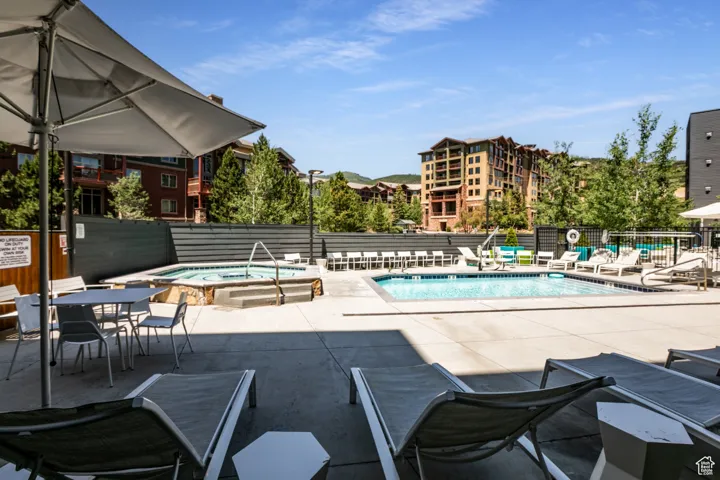 Community pool featuring a patio area and a community hot tub