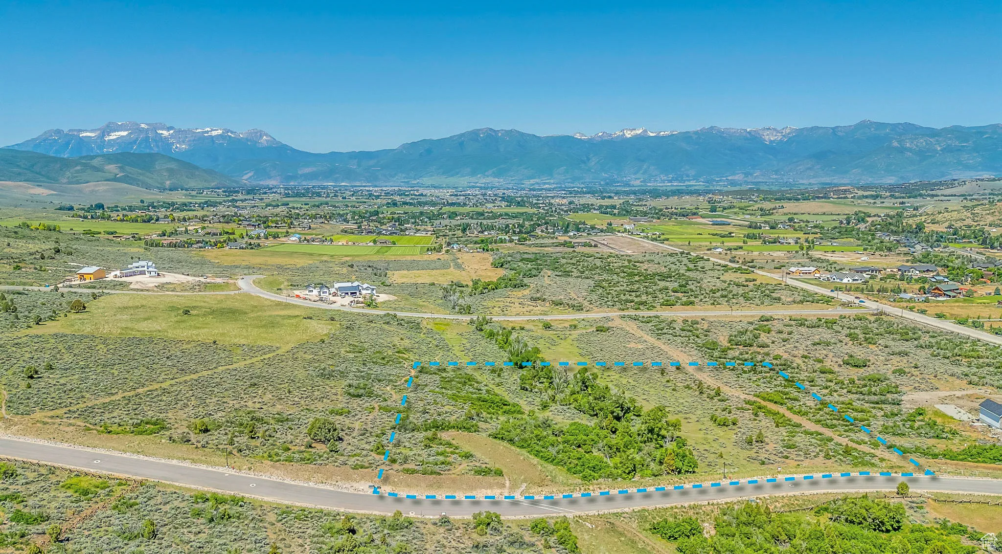 Aerial view of sparsely populated area featuring mountains and property parcel outlined