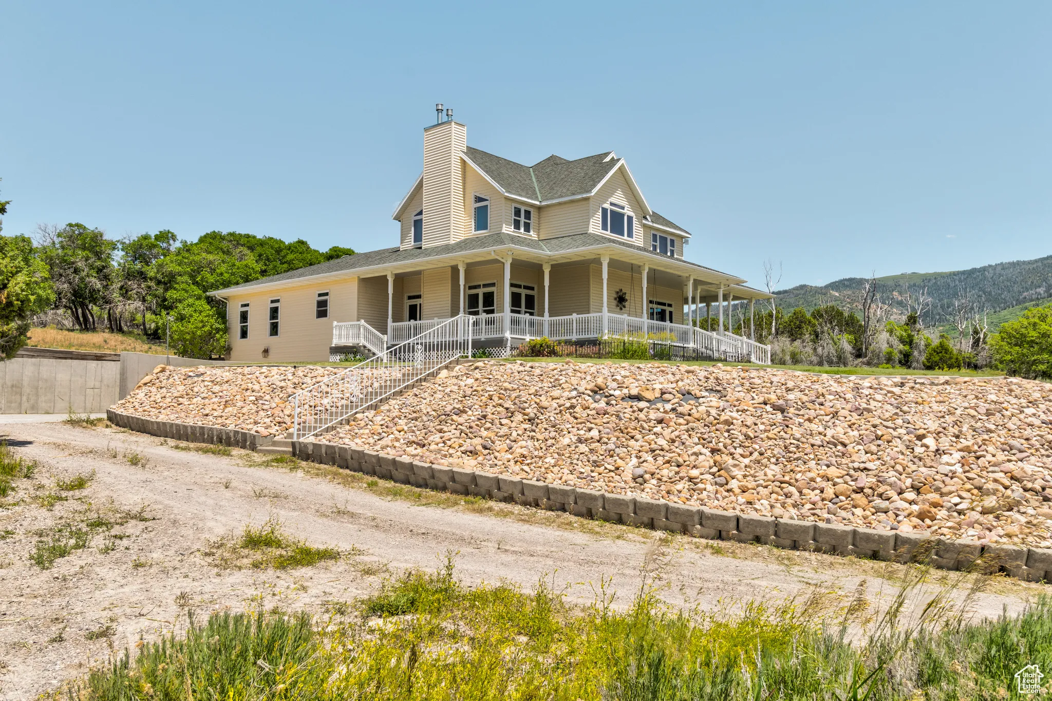 View of front of property with a porch and a chimney