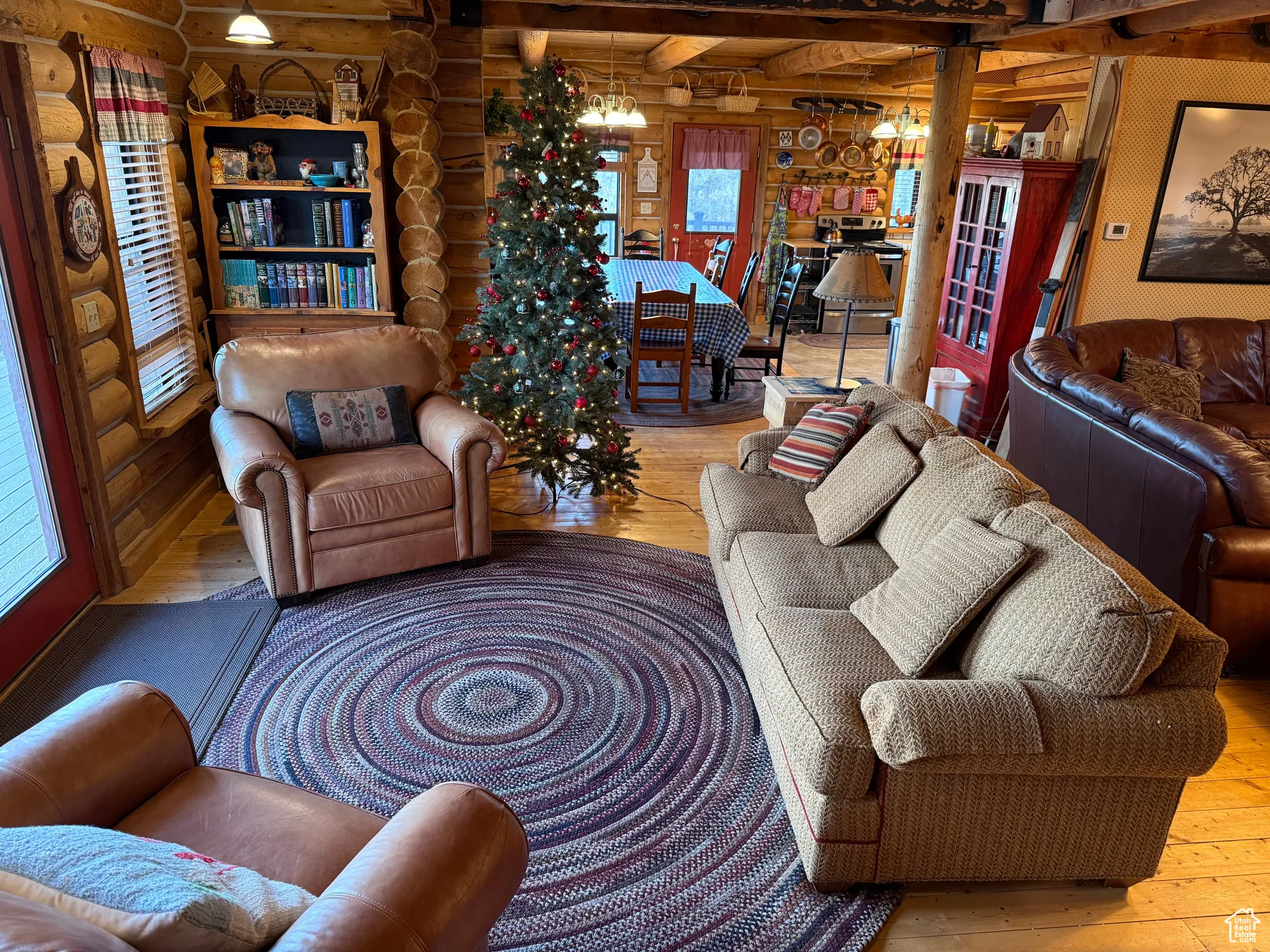 Living room featuring rustic walls, hardwood / wood-style floors, and healthy amount of natural light