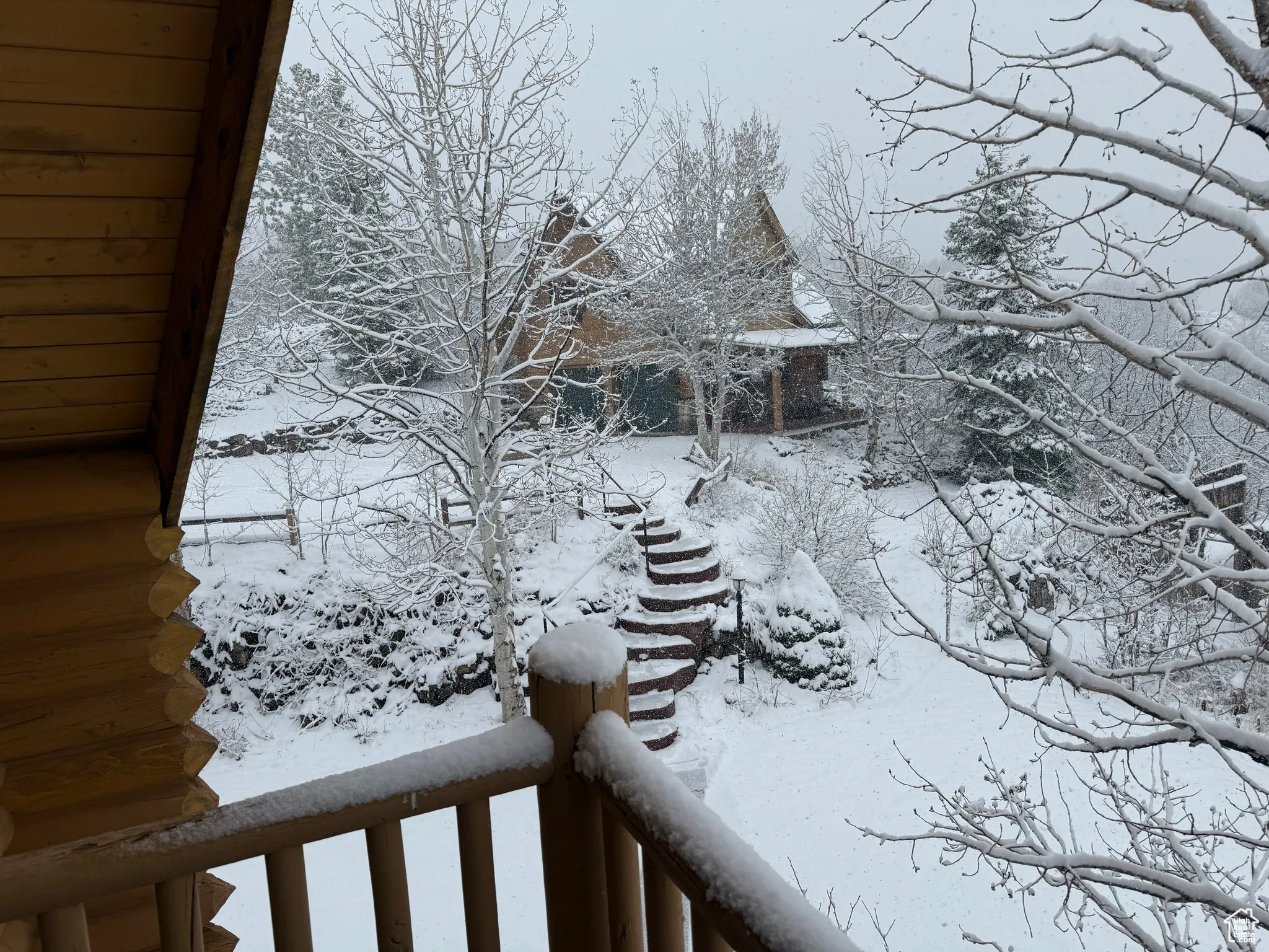 Snowy yard with a balcony