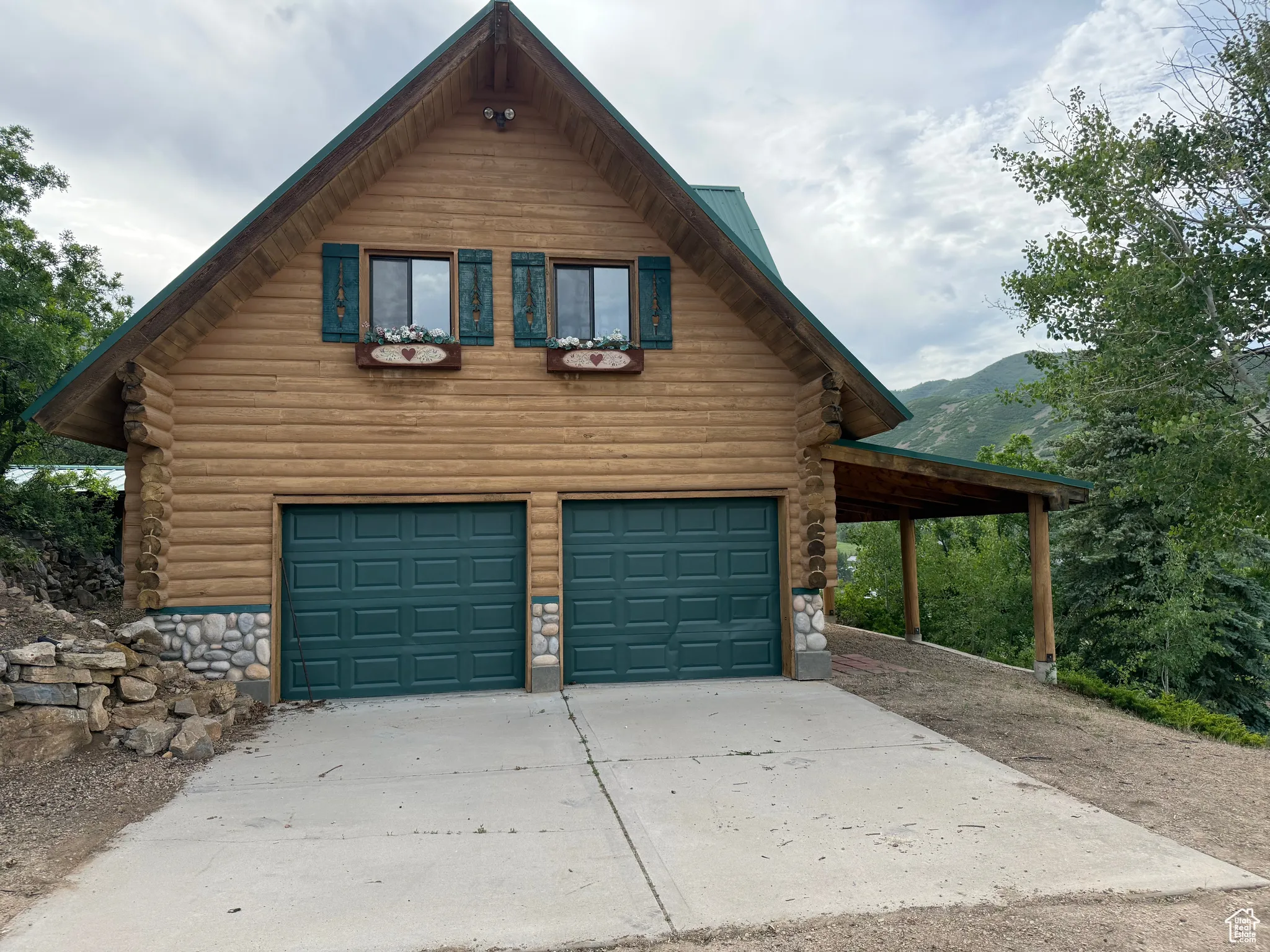 Garage with driveway and a mountain view
