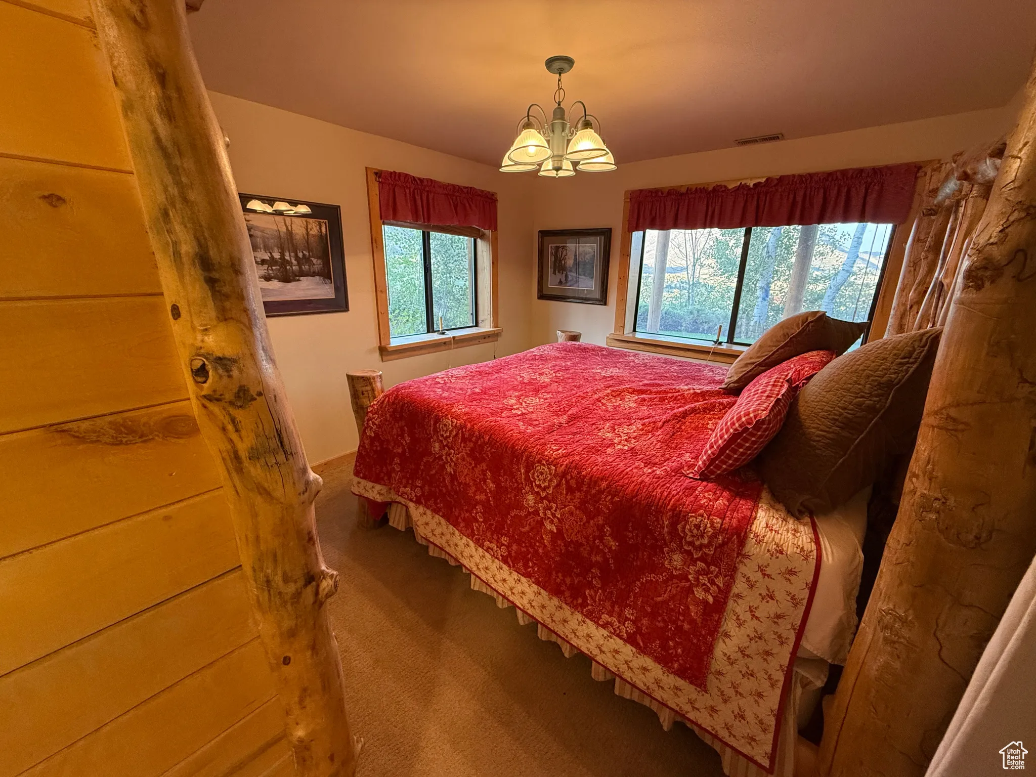 Carpeted bedroom with a chandelier