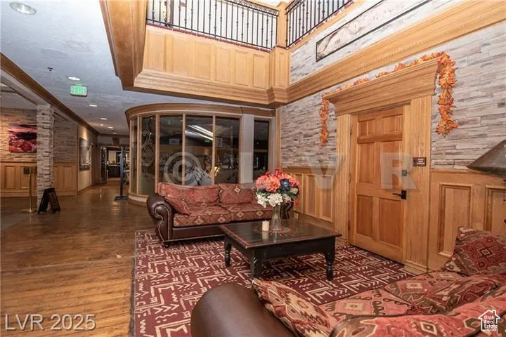 Lobby with a wainscoted wall, crown molding, and recessed lighting