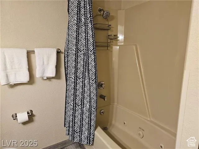 Bathroom featuring shower / bath combination with curtain