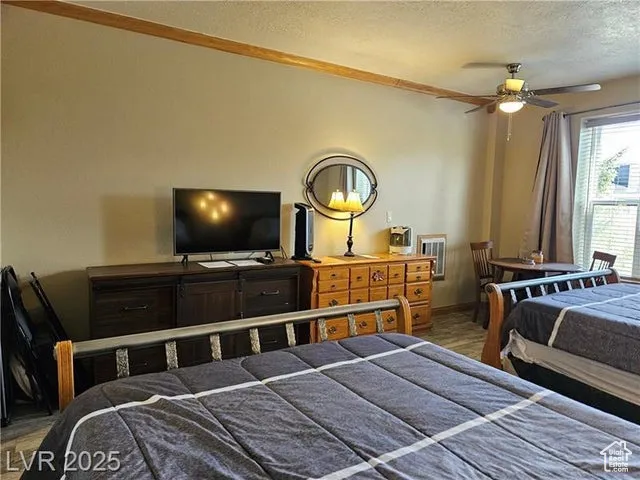 Bedroom featuring a textured ceiling and wood finished floors