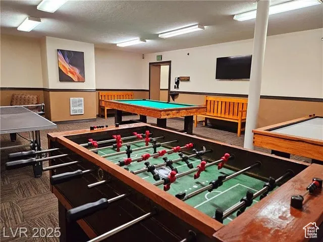 Game room featuring carpet and a textured ceiling