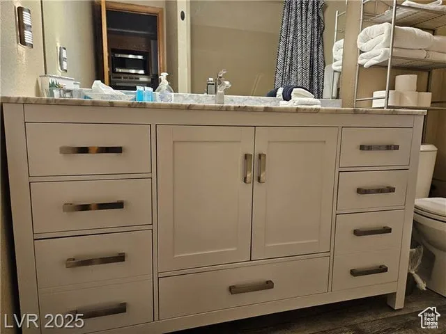 Bathroom featuring vanity and wood finished floors