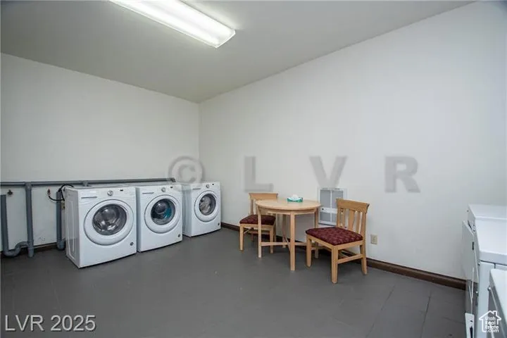 Laundry area with washer and dryer and baseboards