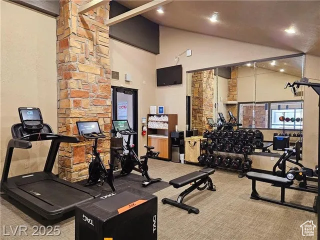 Gym with carpet floors, high vaulted ceiling, and recessed lighting