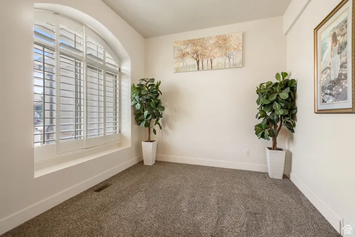 Spare room featuring carpet