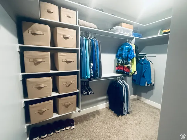 Walk in closet featuring carpet flooring