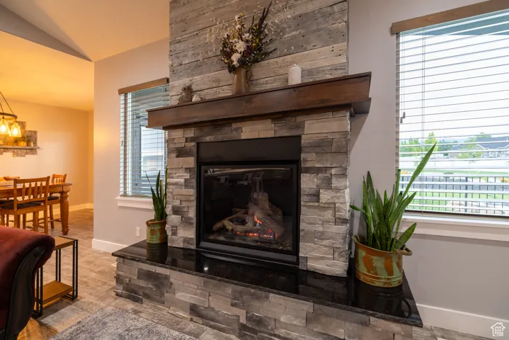 Detailed view of a stone fireplace and baseboards