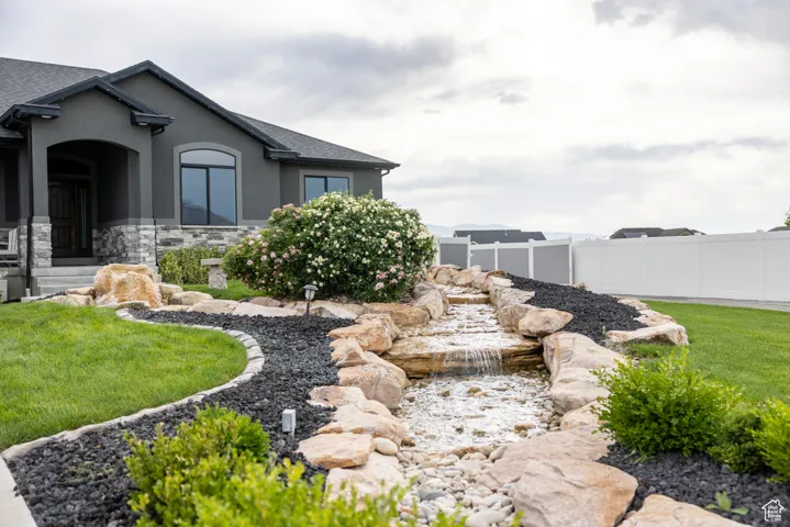 View of yard featuring a small pond