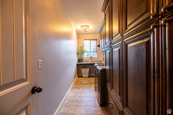 Kitchen featuring a textured ceiling, wood finished floors, and light countertops
