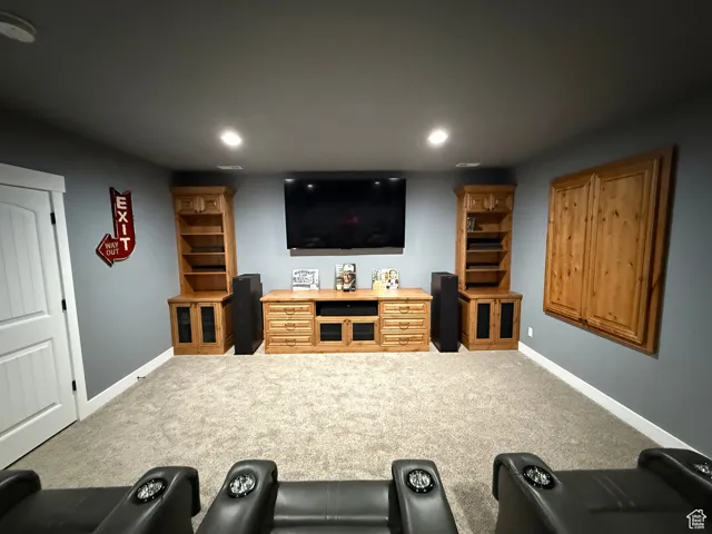Home theater room with recessed lighting and carpet floors