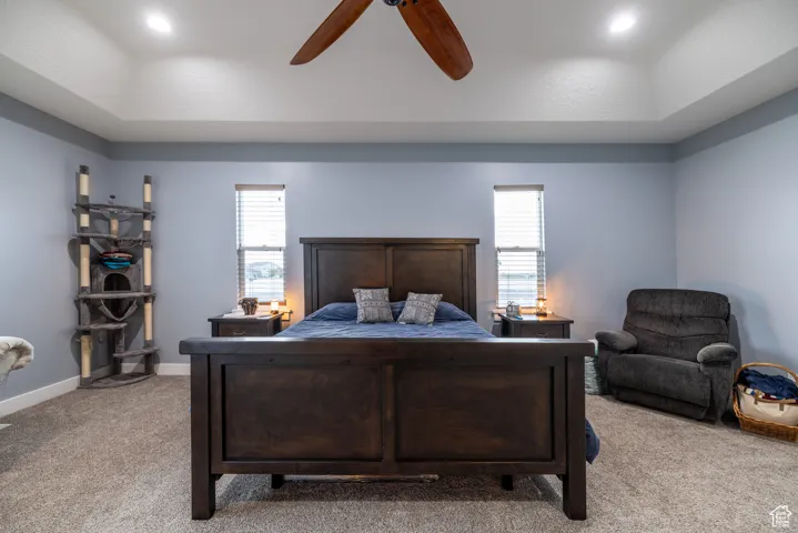 Bedroom featuring light colored carpet and ceiling fan