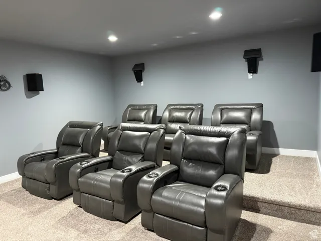 Carpeted home theater room with baseboards and recessed lighting