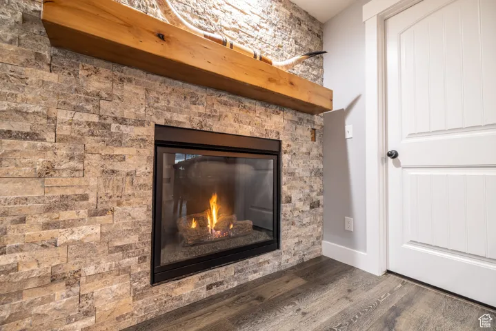 Detailed view of wood finished floors and a glass covered fireplace