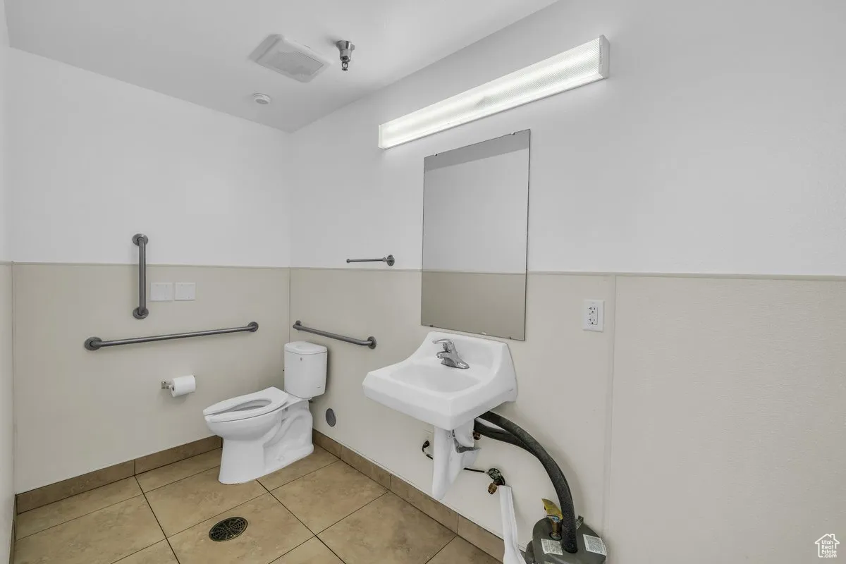 Bathroom featuring toilet and tile patterned flooring