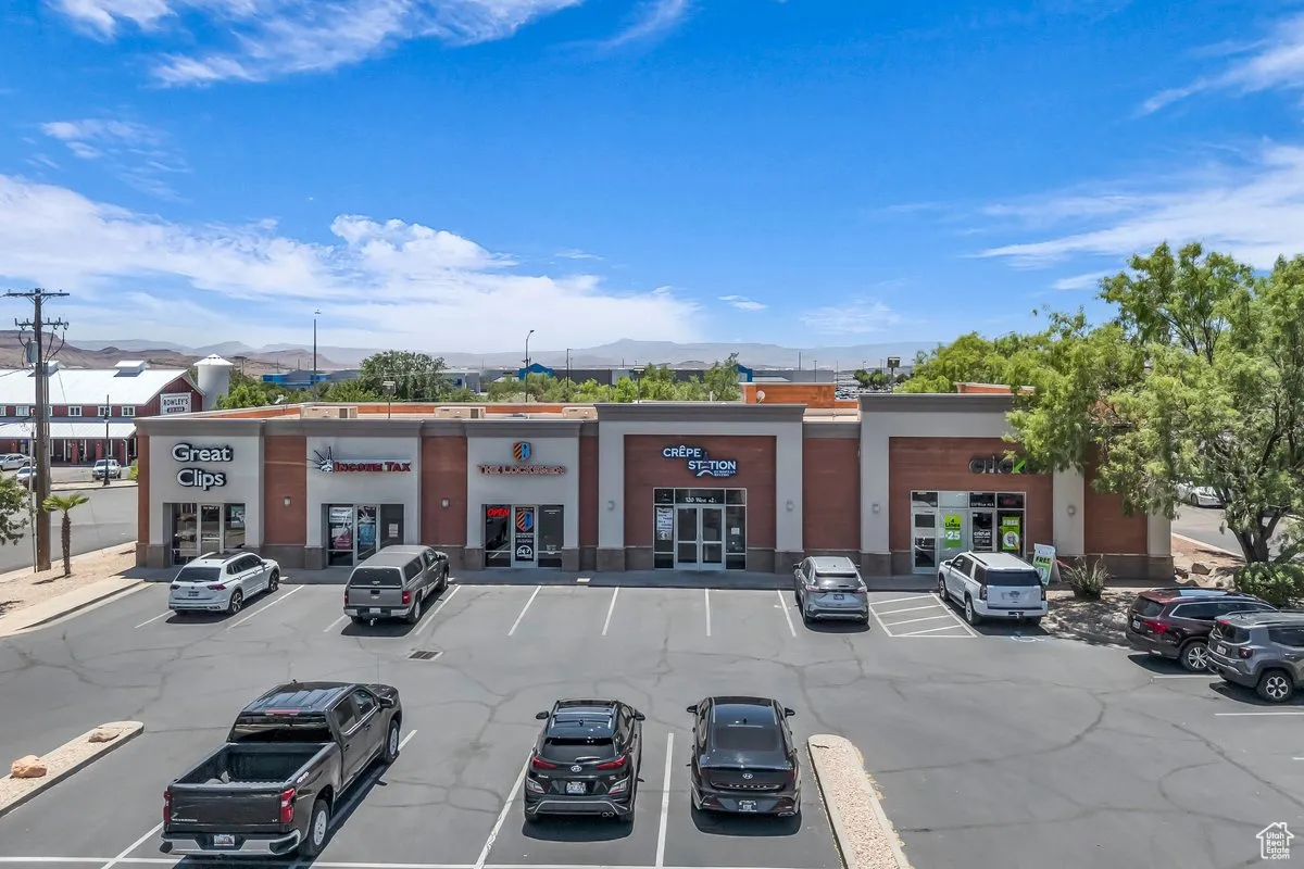 View of commercial property featuring a mountain view and uncovered parking