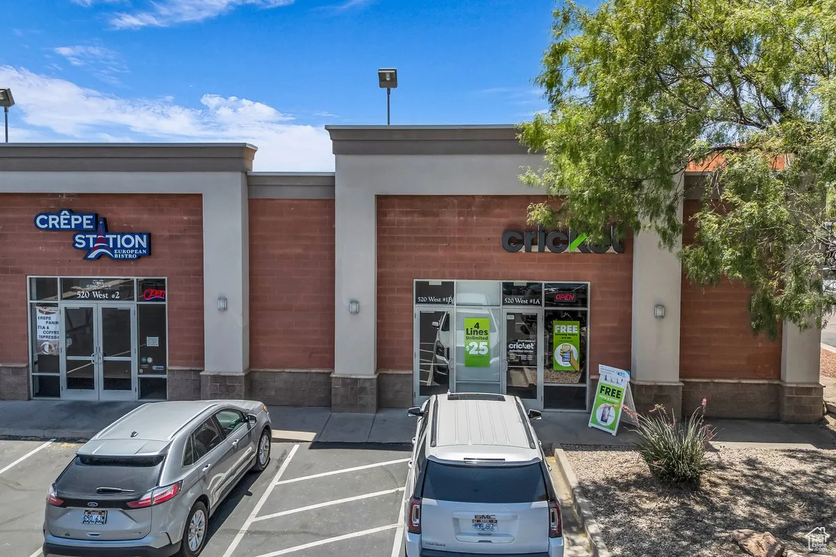 View of commercial property featuring uncovered parking
