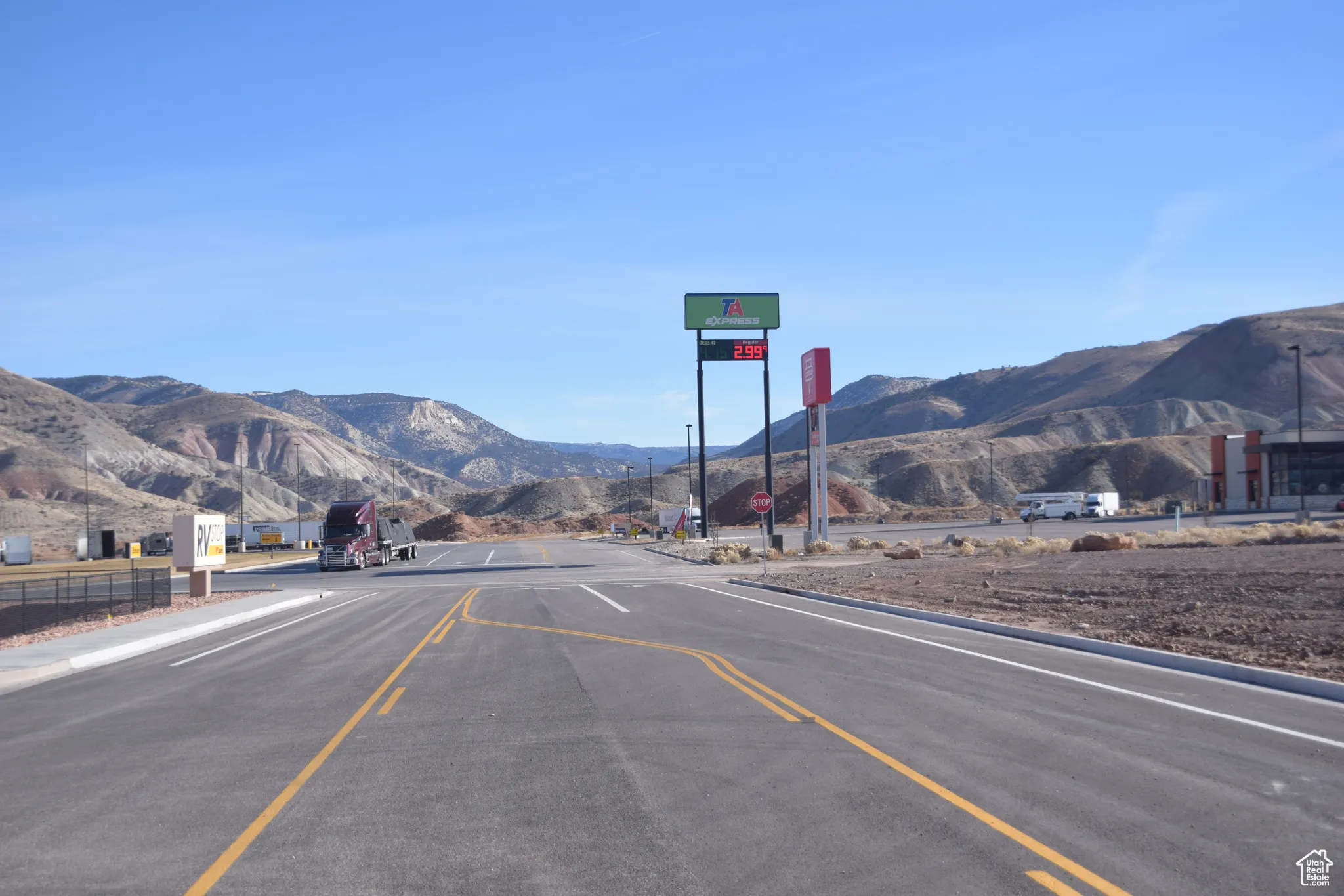 View of asphalt road with a mountain view and traffic signs