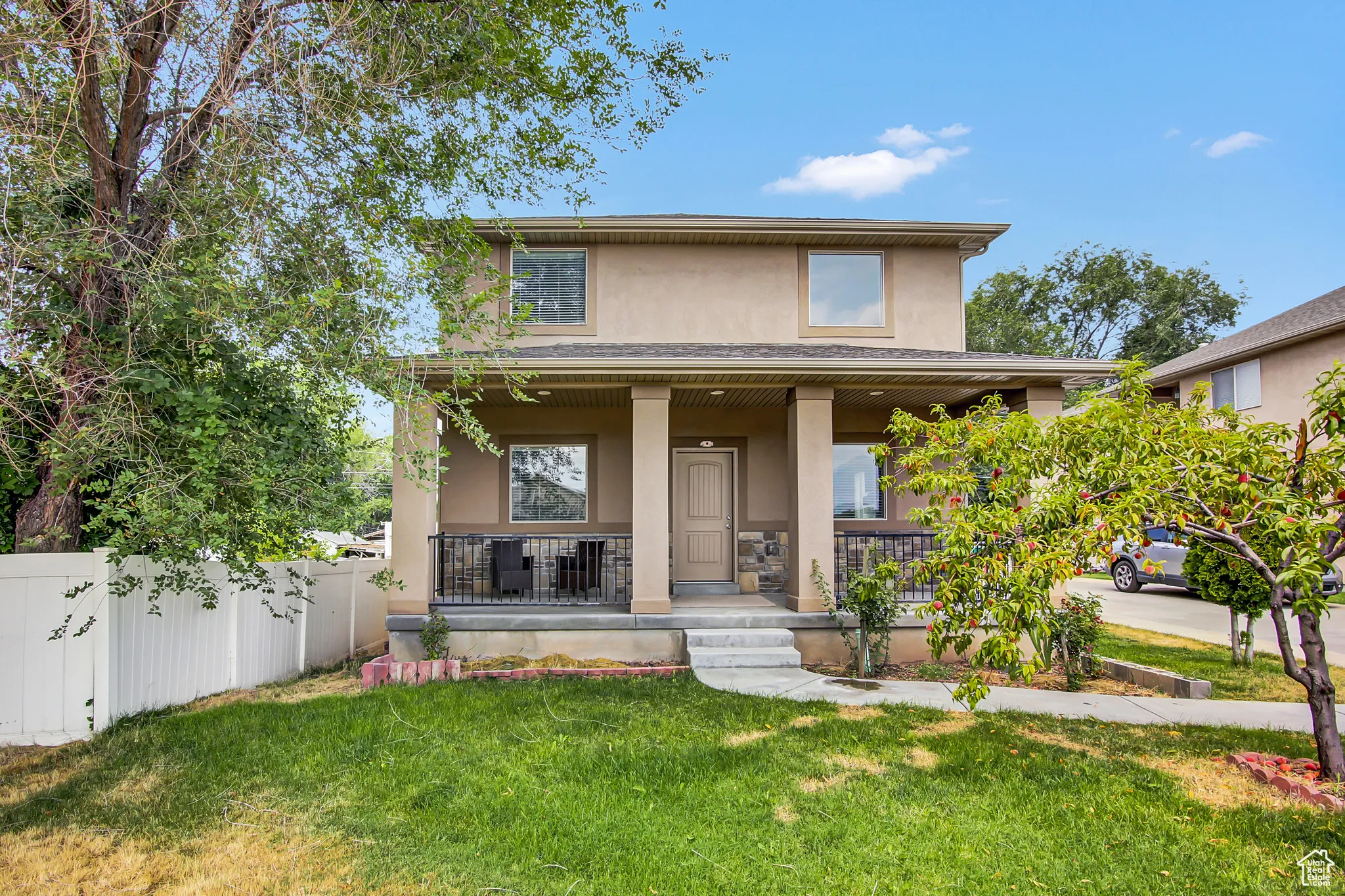 View of front of property featuring a porch and stucco siding