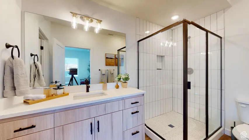 Full bathroom featuring vanity and a shower stall